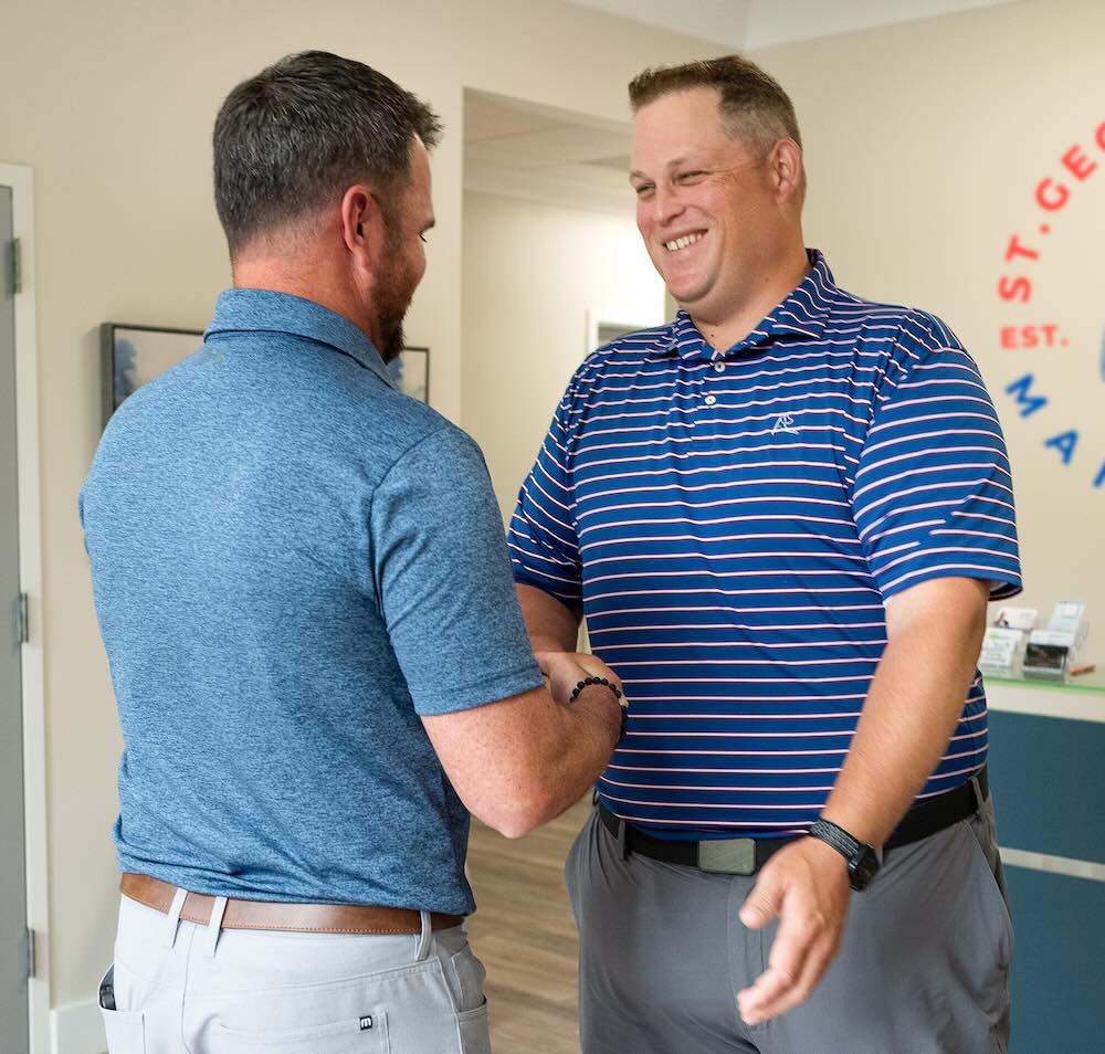 Advisor Nicholas St. George greeting a client