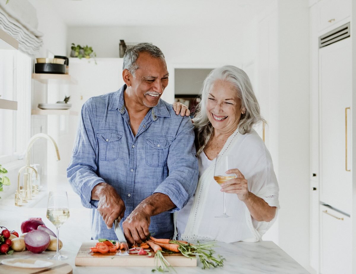 Senior couple cooking at a kitchen